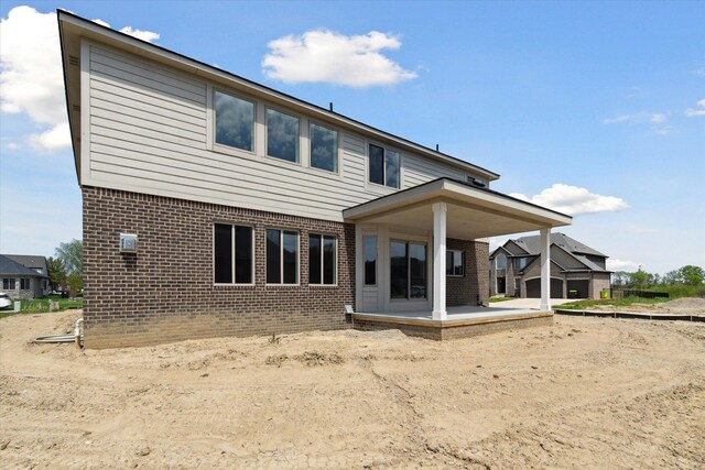 19266 Thompson Dr, Macomb, MI 48042 - rear view of property featuring brick siding and a patio