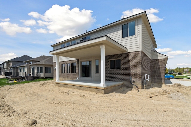 19266 Thompson Dr, Macomb, MI 48042 - rear view of property with brick siding and a patio