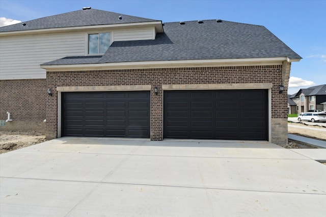 19266 Thompson Dr, Macomb, MI 48042 - view of side of home with brick siding, concrete driveway, an attached garage, and a shingled roof