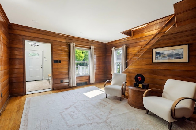 living area featuring wooden walls and light wood-type flooring