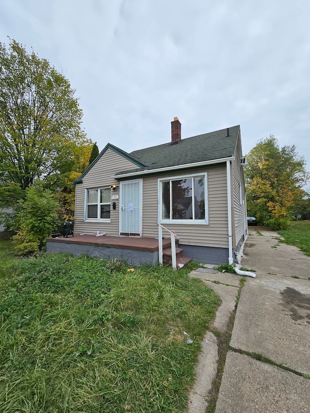 7396 Stahelin Ave, Detroit, MI 48228 - bungalow with a chimney, a shingled roof, driveway, and a deck
