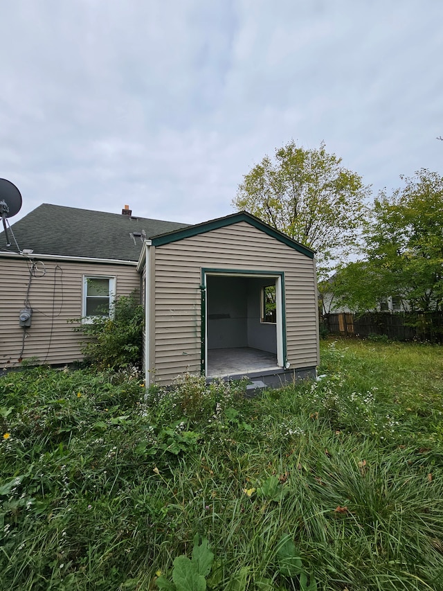 7396 Stahelin Ave, Detroit, MI 48228 - view of property exterior featuring fence, roof with shingles, and an outdoor structure