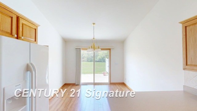 5966 Red Feather Dr, Bay City, MI 48706 - unfurnished dining area featuring light wood finished floors, a chandelier, and baseboards