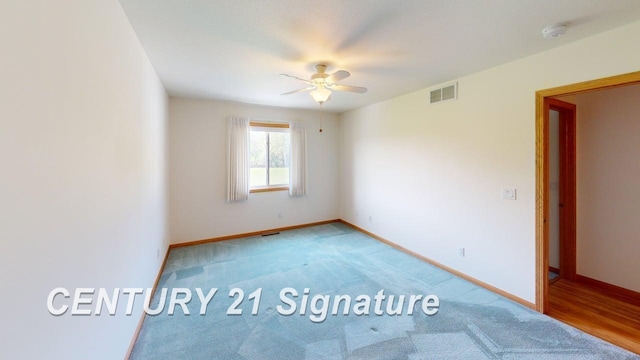 5966 Red Feather Dr, Bay City, MI 48706 - empty room featuring a ceiling fan, light carpet, baseboards, and a smoke detector