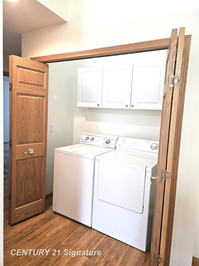 5966 Red Feather Dr, Bay City, MI 48706 - laundry area with cabinet space, independent washer and dryer, and light wood-style flooring