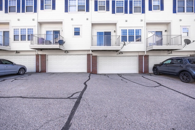 187 Center Blvd, Wixom, MI 48393 - view of front facade with a garage, brick siding, and driveway