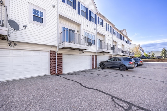 187 Center Blvd, Wixom, MI 48393 - view of property with a garage, a residential view, and driveway