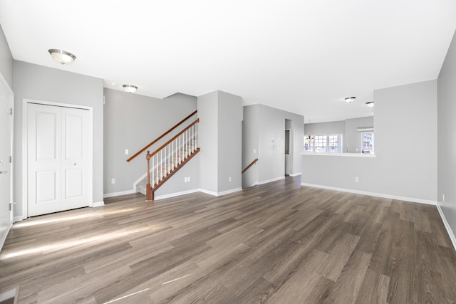 187 Center Blvd, Wixom, MI 48393 - unfurnished living room with wood finished floors, stairs, and baseboards