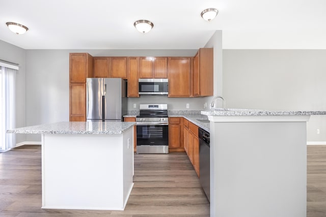 187 Center Blvd, Wixom, MI 48393 - kitchen with appliances with stainless steel finishes, a sink, and wood finished floors