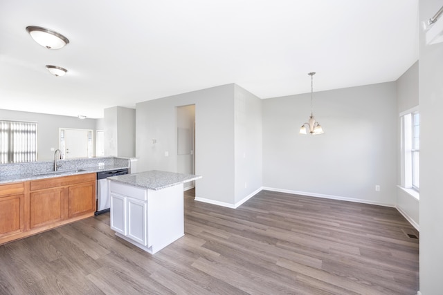 187 Center Blvd, Wixom, MI 48393 - kitchen with a sink, dishwasher, a chandelier, dark wood-style floors, and baseboards