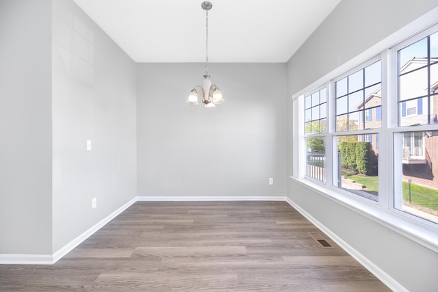 187 Center Blvd, Wixom, MI 48393 - spare room with a chandelier, plenty of natural light, and baseboards