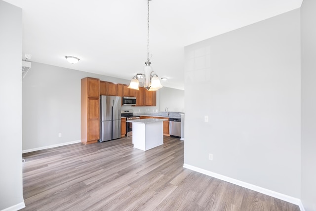 187 Center Blvd, Wixom, MI 48393 - kitchen featuring appliances with stainless steel finishes, a chandelier, light wood-style floors, and baseboards