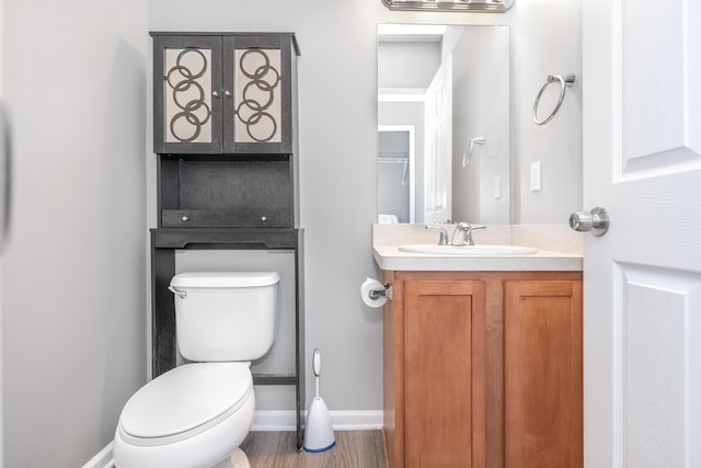 187 Center Blvd, Wixom, MI 48393 - half bathroom featuring baseboards, vanity, toilet, and wood finished floors