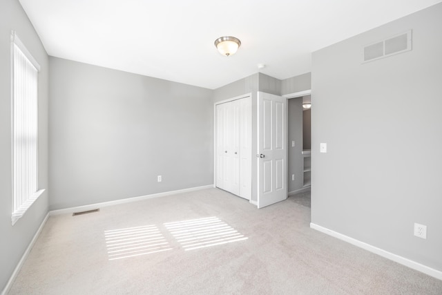 187 Center Blvd, Wixom, MI 48393 - unfurnished bedroom featuring carpet flooring, a closet, and baseboards