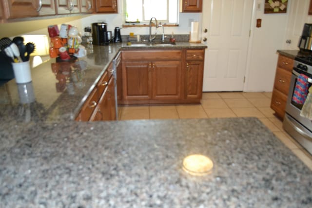 5448 Fairview Dr, Grand Blanc, MI 48439 - kitchen featuring a sink, brown cabinetry, light stone countertops, and stainless steel dishwasher