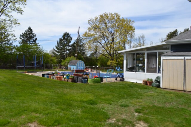 5448 Fairview Dr, Grand Blanc, MI 48439 - view of yard with a storage unit, a sunroom, and an outbuilding