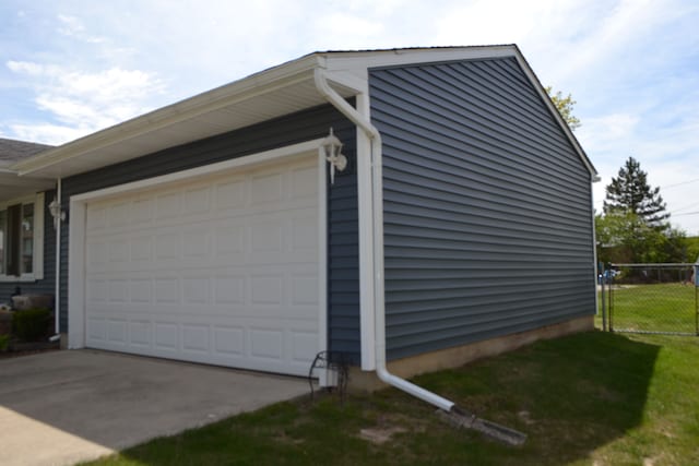 5448 Fairview Dr, Grand Blanc, MI 48439 - view of side of home featuring fence, concrete driveway, and an attached garage