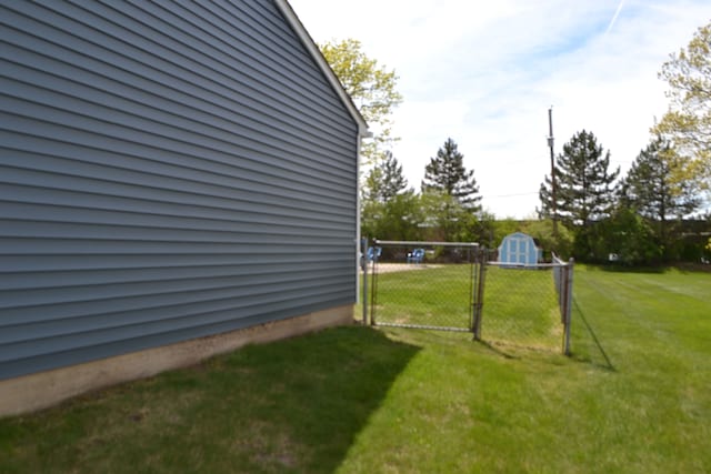 5448 Fairview Dr, Grand Blanc, MI 48439 - view of green lawn with a gate, a storage unit, and an outdoor structure