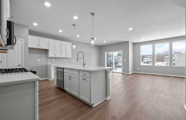 4076 Nottingham Cir, Clarkston, MI 48346 - kitchen with stainless steel appliances, a sink, light countertops, white cabinetry, and recessed lighting