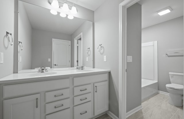 4076 Nottingham Cir, Clarkston, MI 48346 - bathroom with toilet, baseboards, double vanity, and a bathtub