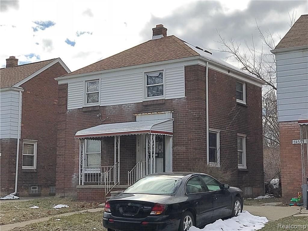 view of front of house with brick siding, a chimney, and covered porch