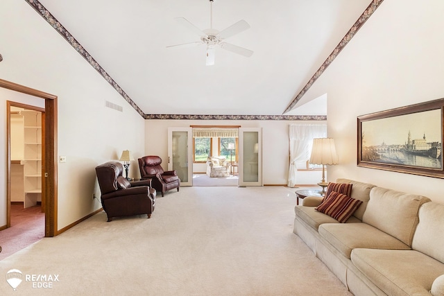 living room featuring light carpet, baseboards, high vaulted ceiling, and a ceiling fan