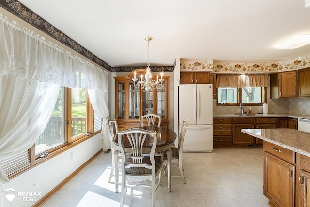 dining space with a chandelier and light flooring