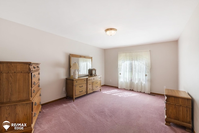 bedroom with carpet flooring and baseboards