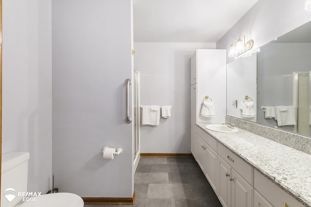 full bath with toilet, baseboards, vanity, and an enclosed shower