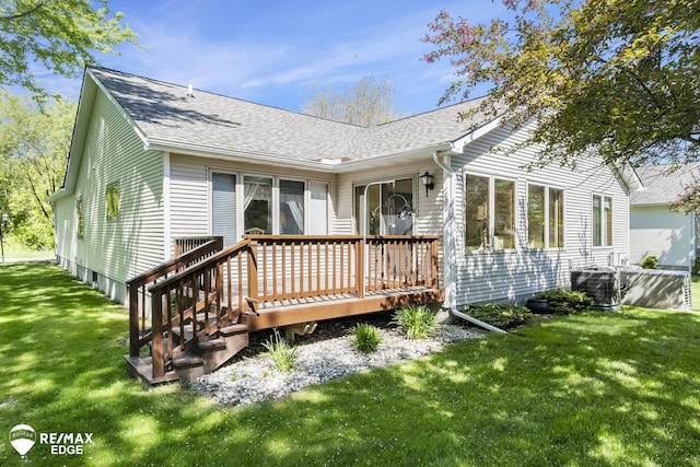 back of property featuring central air condition unit, a deck, a shingled roof, and a yard