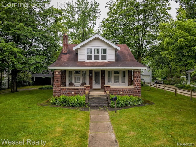 337 Chandler St, Romeo, MI 48065 - bungalow featuring brick siding, covered porch, a chimney, and a garage