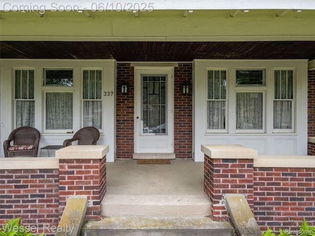 337 Chandler St, Romeo, MI 48065 - doorway to property with a porch and brick siding