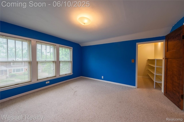337 Chandler St, Romeo, MI 48065 - spare room featuring vaulted ceiling, carpet flooring, and baseboards