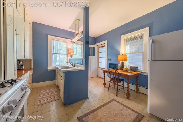 337 Chandler St, Romeo, MI 48065 - kitchen featuring white appliances, baseboards, a sink, light flooring, and baseboard heating