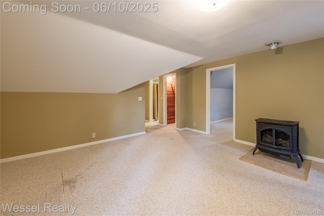 337 Chandler St, Romeo, MI 48065 - unfurnished living room featuring a wood stove, vaulted ceiling, and baseboards