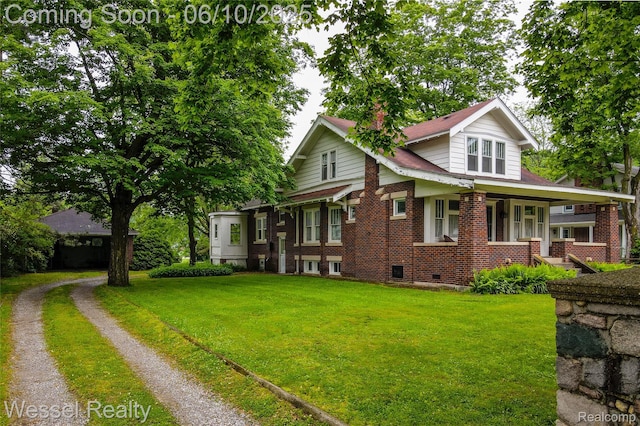 337 Chandler St, Romeo, MI 48065 - view of front facade with a front yard, brick siding, and a porch