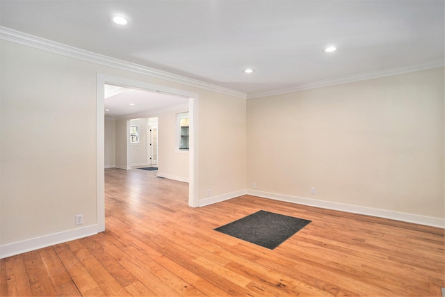 unfurnished room featuring crown molding, light wood-style flooring, baseboards, and recessed lighting