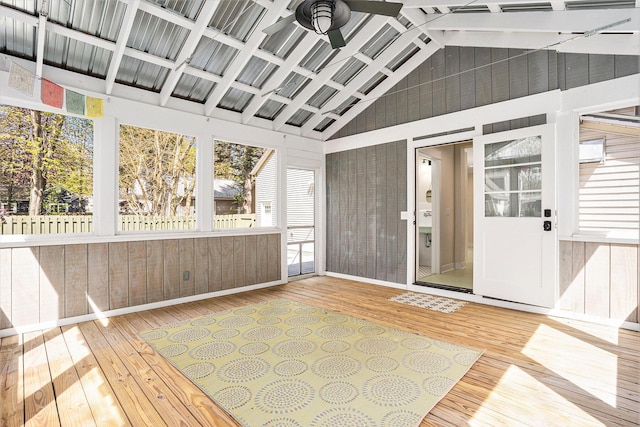 unfurnished sunroom with a ceiling fan and plenty of natural light