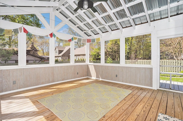 unfurnished sunroom featuring ceiling fan