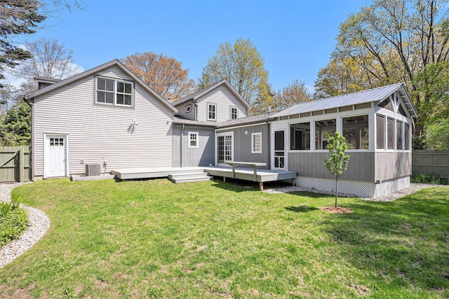 rear view of house featuring a deck and a sunroom