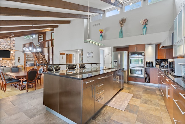 343 Shotwell, White Lake, MI 48386 - kitchen with stainless steel appliances, a towering ceiling, a sink, beam ceiling, and an island with sink