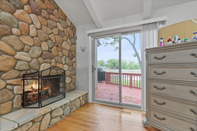 343 Shotwell, White Lake, MI 48386 - detailed view of beamed ceiling, wood finished floors, and a stone fireplace