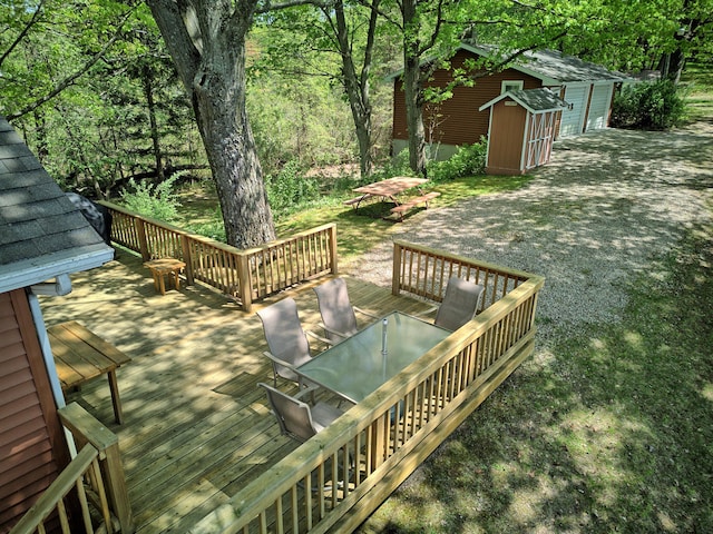 15065 Becker Dr, Mecosta, MI 49332 - deck featuring outdoor dining space, a shed, and an outbuilding