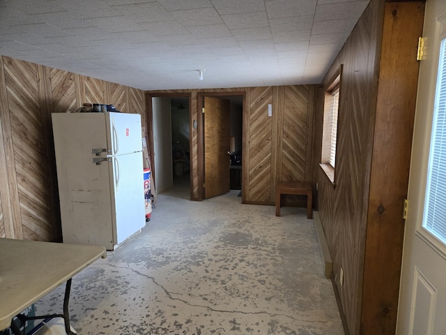 15065 Becker Dr, Mecosta, MI 49332 - below grade area with freestanding refrigerator and wood walls