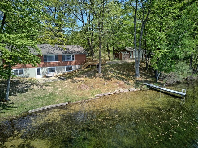 15065 Becker Dr, Mecosta, MI 49332 - view of yard featuring a shed, an outdoor structure, a dock, stairway, and a wooden deck
