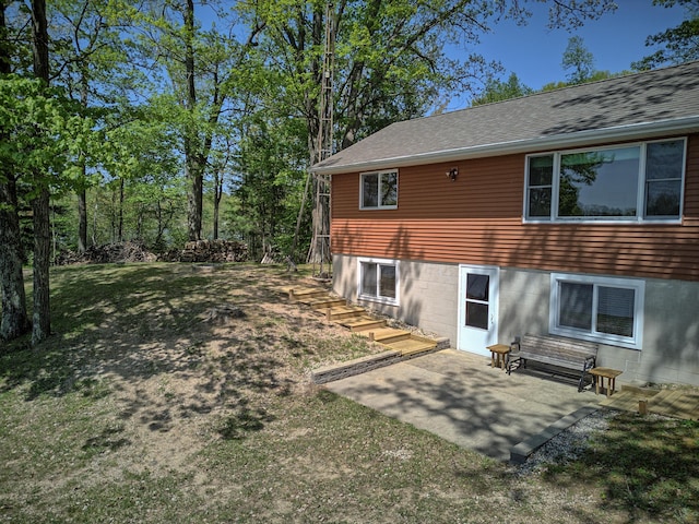 15065 Becker Dr, Mecosta, MI 49332 - back of house featuring a lawn, a patio area, and roof with shingles