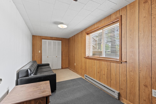 15065 Becker Dr, Mecosta, MI 49332 - interior space with a baseboard radiator, wooden walls, and carpet floors