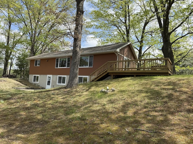 15065 Becker Dr, Mecosta, MI 49332 - rear view of house featuring stairway, a deck, and a lawn