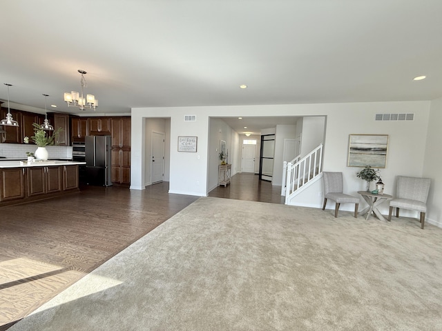 living area with a chandelier, baseboards, recessed lighting, dark colored carpet, and dark wood finished floors