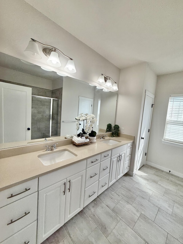 bathroom featuring a shower stall and double vanity